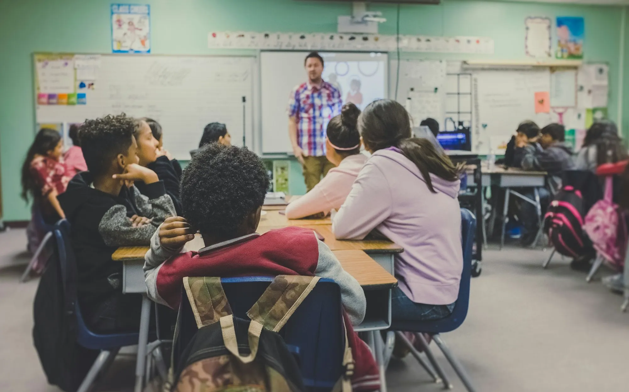 Students at laptops in a classroom
